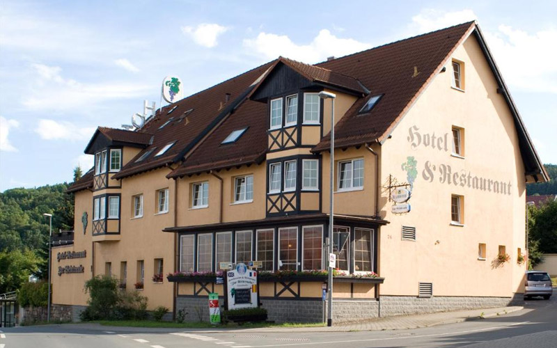 Hotel & Restaurant Zur Weintraube in Jena – traditionsreiches Haus mit regionaler Küche und gemütlichem Ambiente Außenansicht des Hotels & Restaurants Zur Weintraube in Jena, charmantes Gebäude mit einladender Terrasse und umgebender Stadtlandschaft